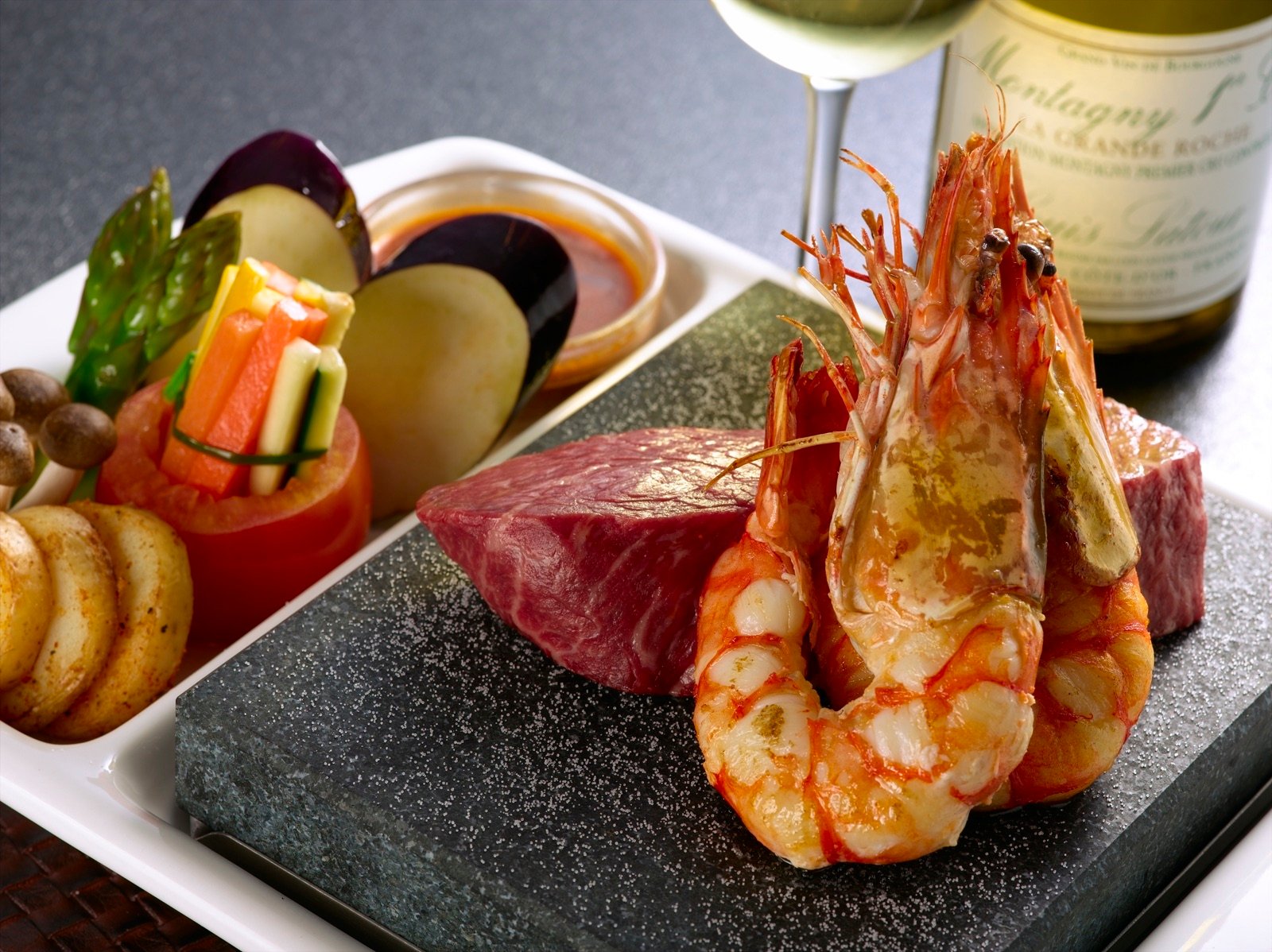 Wagyu rump with prawns and scallops on a hot volcanic stone